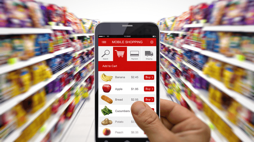 hand holding phone online shopping, in grocery store isle