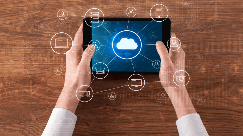 hands holding tablet with multiple datapoint icons
