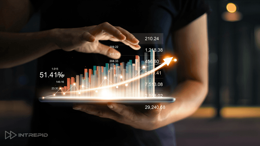 hands holding tablet with superimposed graph trending up